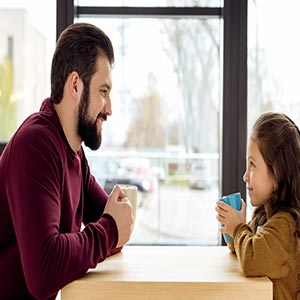 father and daughter talking over coffee