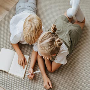 kids sitting on ground studying